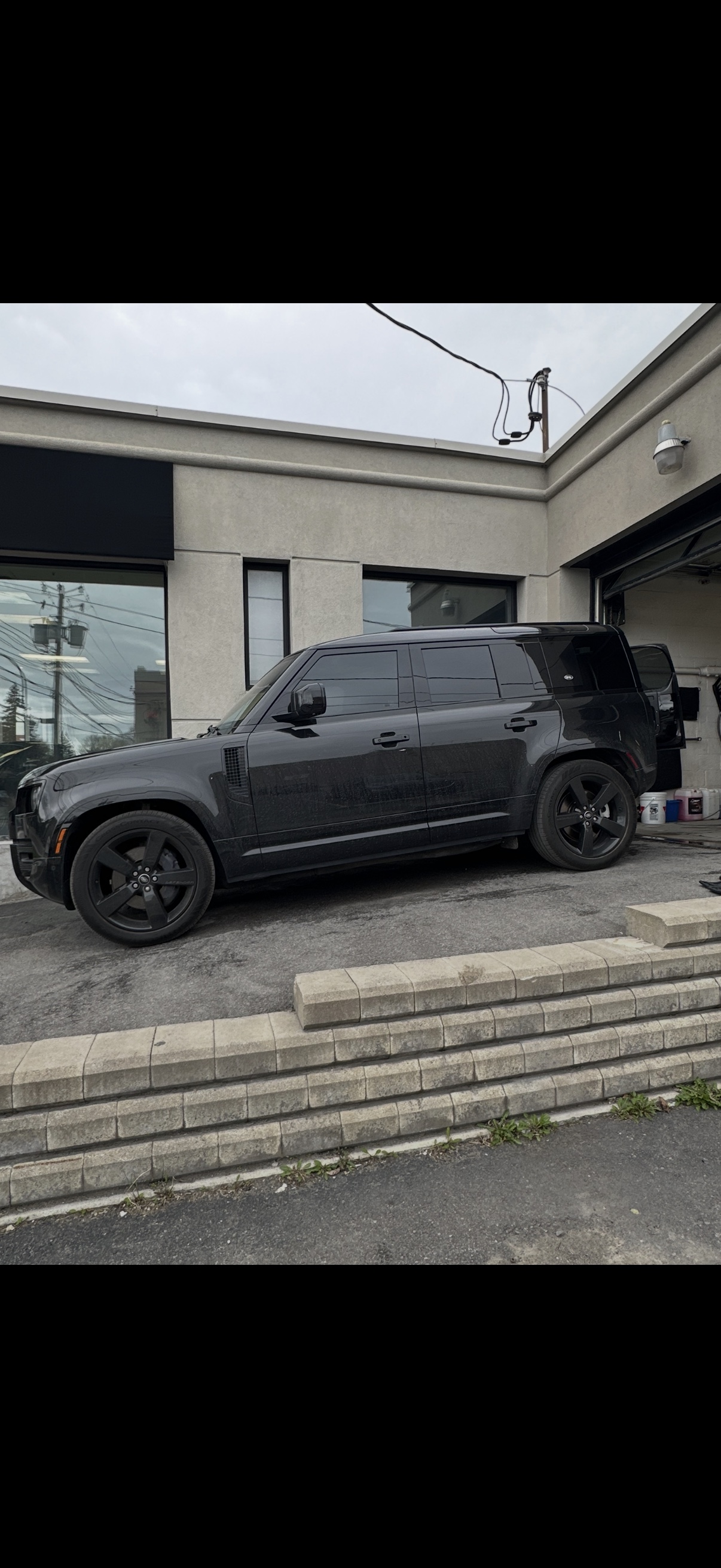 Dusty black Land Rover Defender before exterior detailing