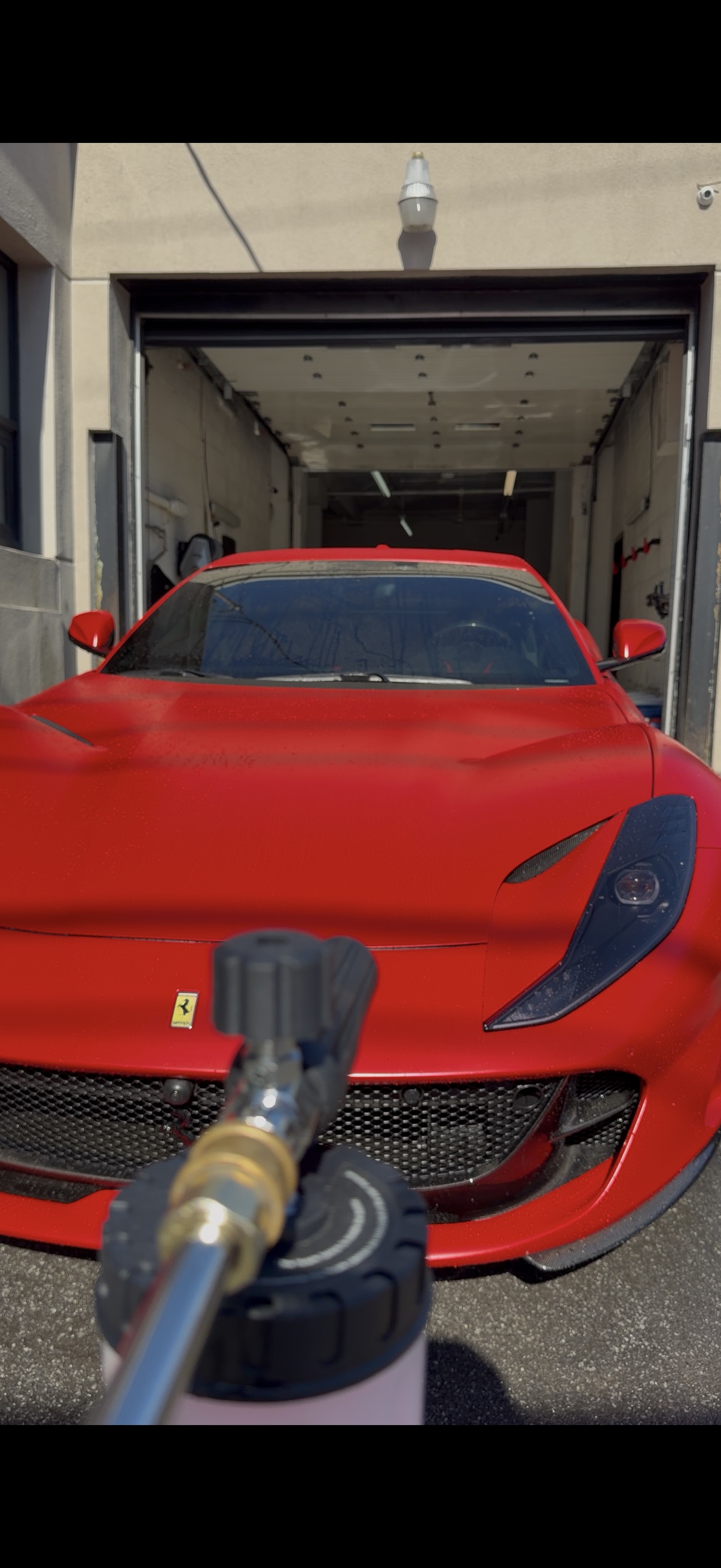 Red Ferrari being prepared for an exterior detail at Paramount Details