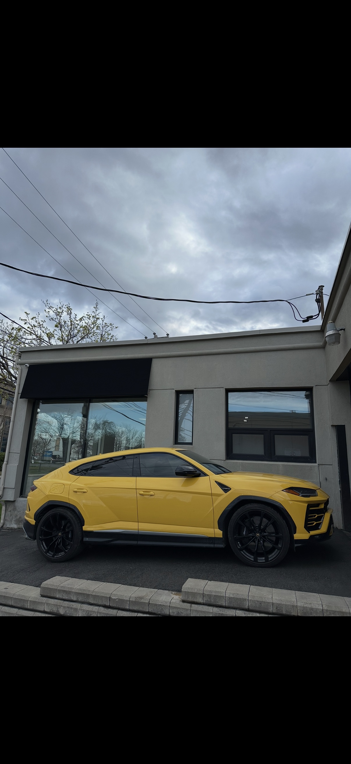 Yellow Lamborghini Urus outside the workshop