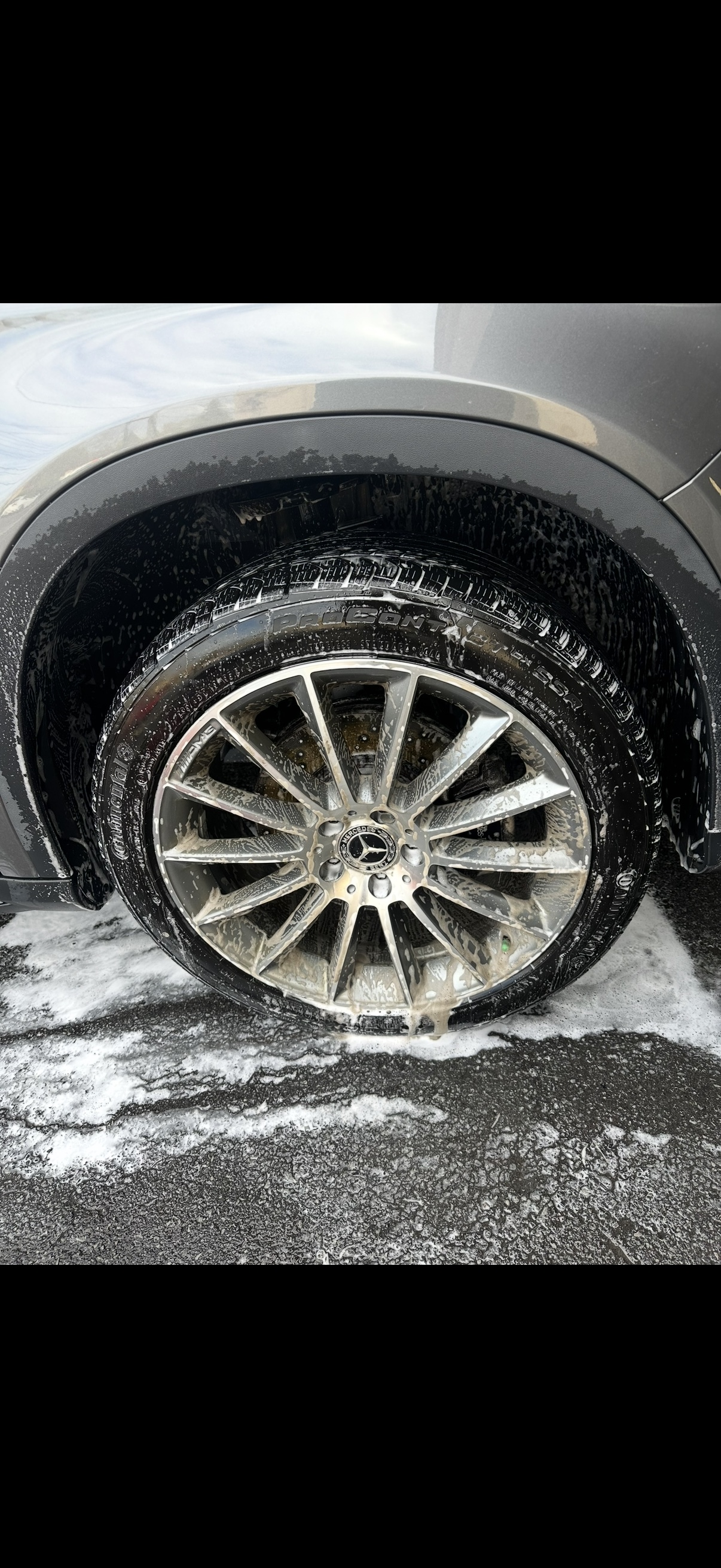 Mercedes-Benz wheel being cleaned with detailing foam